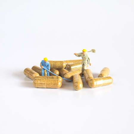 Worker figure with herb drug capsule ,health concept.