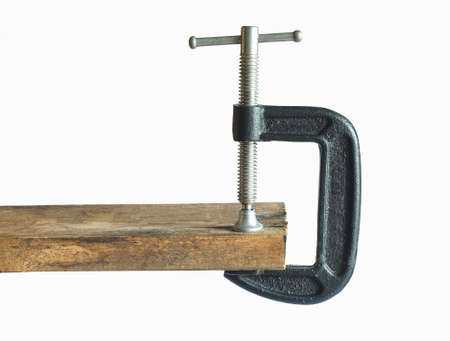 Metal Clamp tool on Wood on background.の写真素材