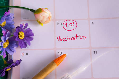 Appointment to vaccination on calendar to reminder.の写真素材