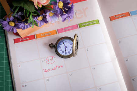 Wording Vaccinaton on calendar with vintage pocket watch ,appiontment for health .