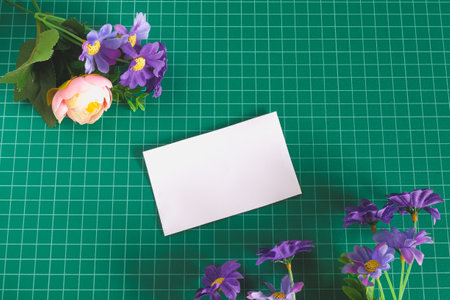 White paper card on green cutting board .の写真素材