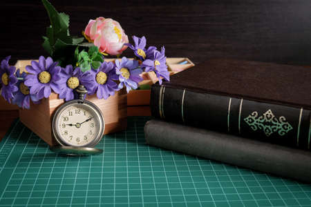 Vintage pocket watch and a business tool on table.