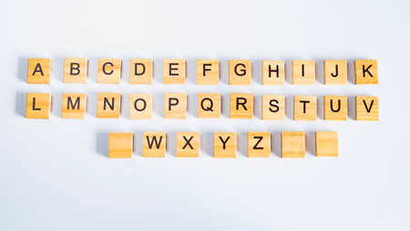 Alphabet letters on wooden pieces. Set light text on computer keyboard.の写真素材