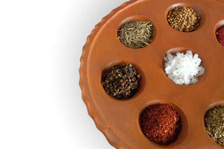 Different spices and herbs in clay pit tray for cooking Thai food on background.の写真素材