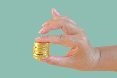 Golden coins money  in hand on background.