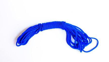 Blue rope for climbing equipment on a white background.