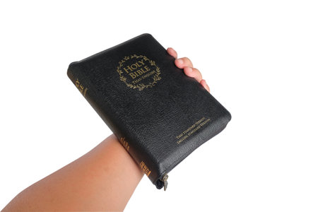 Books of the Bible in hand on white.clipping path.