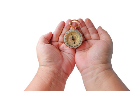 Hand holding a compass on white background.の写真素材