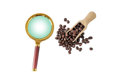 Coffee beans in wooden scoop with magnifier on white background.の写真素材