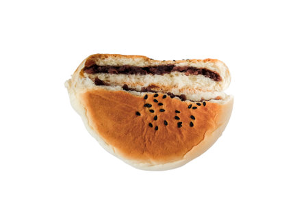 A half of round bread sweet red bean bread on white background.の写真素材