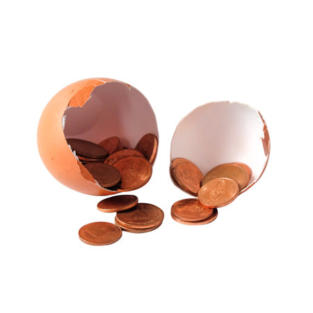 A coin in egg shell on white background.の写真素材
