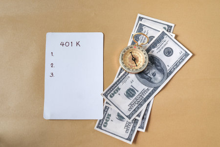 401k  Plan and Gold compass on pile of US money.の写真素材