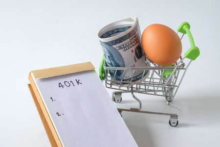 401k  Plan note with egg and Pile of US Money.の写真素材