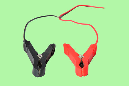 Red and black car battery jumper cables on background.の写真素材