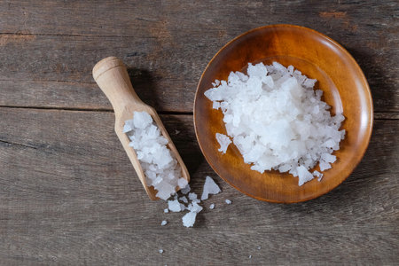 Sea salt on wooden dish with scoop . concept of healthy lifestyle.の写真素材