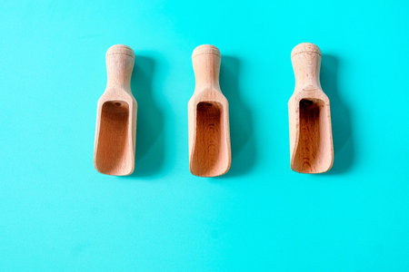 Wooden spoon, chopsticks and equipment on a color background. Top view.
