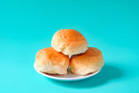 Fresh buns in baking dish on table.の写真素材