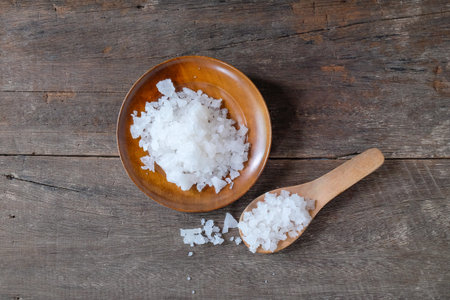 Sea salt on wooden dish with scoop . concept of healthy lifestyle.の写真素材