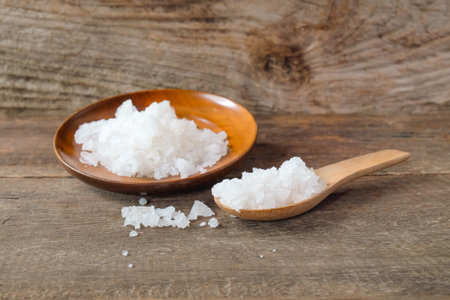 Sea salt on wooden dish with scoop . concept of healthy lifestyle.の写真素材