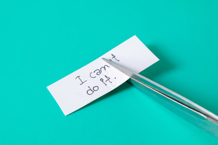 To cutting paper note with scissors to remove T word from I can't do it .の写真素材