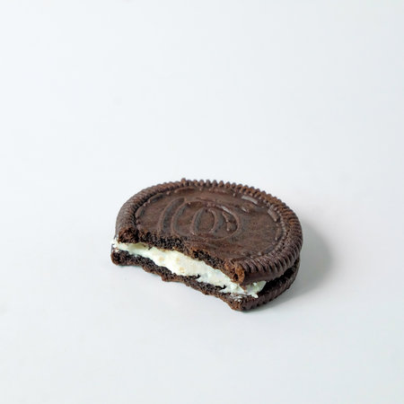 Chocolate cookie with cream on background.の写真素材