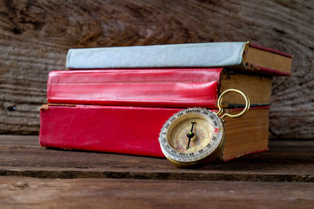 Antique Compass Resting on a red old Book .の写真素材