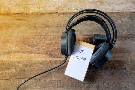 We listen text written on notebook covered with headphones.の写真素材