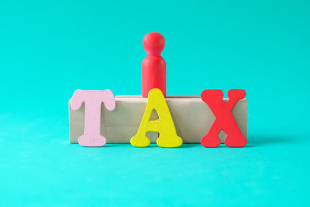 Wooden figure standing,Word Tax made with wooden letters.の写真素材