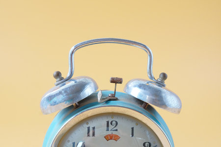 Old alarm clock with bell on the top, antique classic alarm clock.