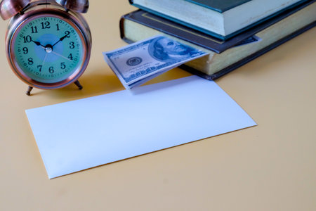 A pile of books with US banknotes, saving hidden.