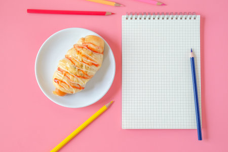 Bread with Sausage and topping with cheese and notebook.の写真素材