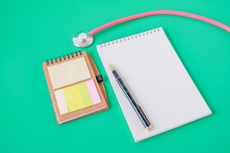 Stethoscope and noted book with pen.Selective focus .の写真素材