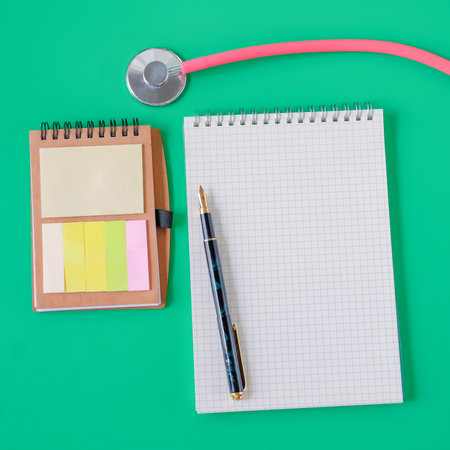 Stethoscope and noted book with pen.Selective focus .の写真素材