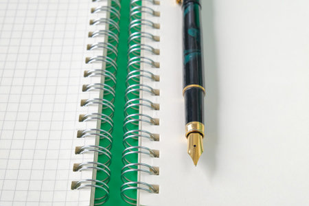Top view of Fountain pen on book note .