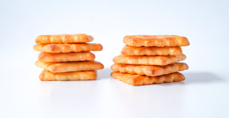 Square biscuits coconut over a white background.の写真素材