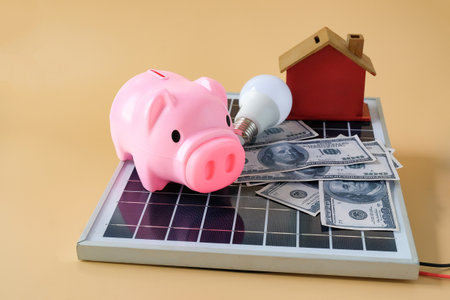 Composition with solar panel, led lamp, money and piggy bank on texture background.の写真素材