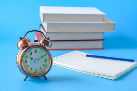 Alarm clock with books.back to school concepts.