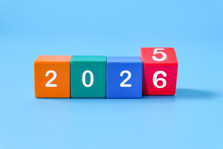 From 2025 to 2026, numbers on wood blocks. On color background.