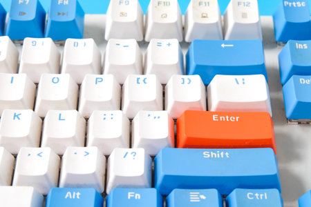 Computer keyboard on blue background. Top view