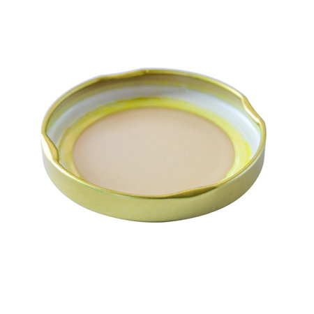 A golden jar lid or cap on background.の写真素材