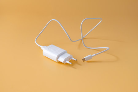A phone charger and USB cable on background.の写真素材