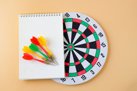 Dart board game with book note, Business game concept.の写真素材