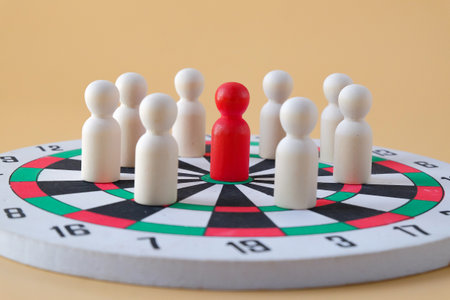 Wooden dolls on dart board,Cooperation and interaction.の写真素材
