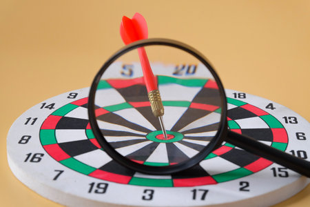 Dart board game with magnifying, Leader concept.の写真素材