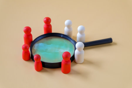 Wooden figures with magnifier ,human resources, Recruitment employee concept.の写真素材
