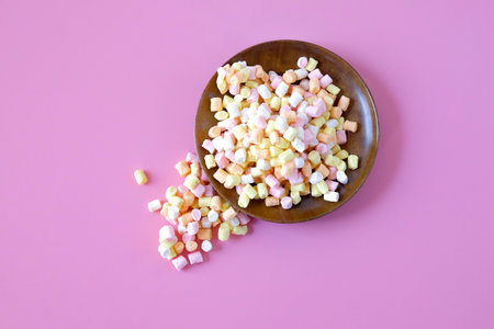 Colorful sweet candy in wood dish on background.