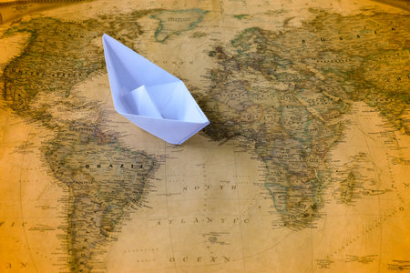 Paper boat or ship on Vintage world map, Paper craft or origami.