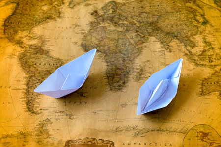 Paper boat or ship on Vintage world map, Paper craft or origami.