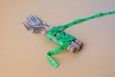 Green tape measure wrapped around fork.