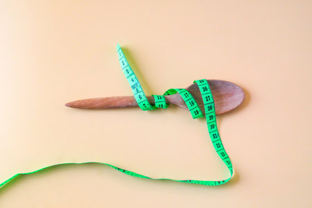 A Measuring tape for tying wood spoon,diet, healthy lifestyle concept.